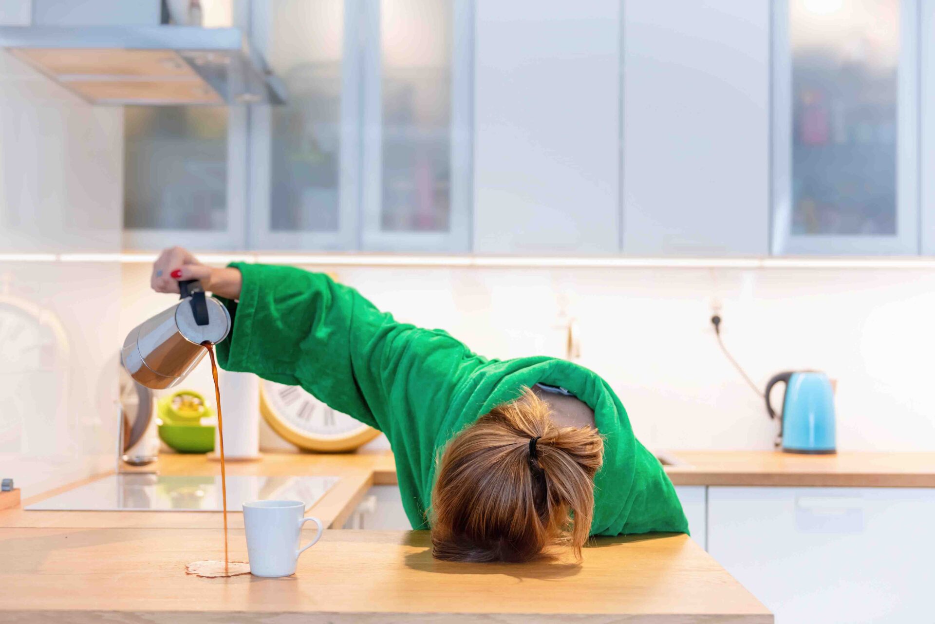 A woman is pouring something in the cup.